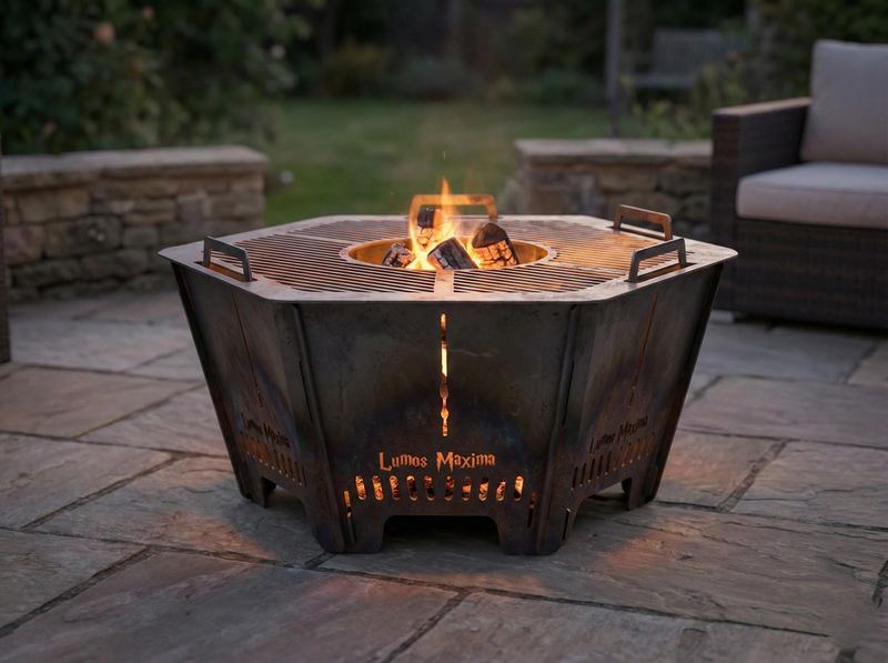 Hexagon steel fire pit burning on a stone patio