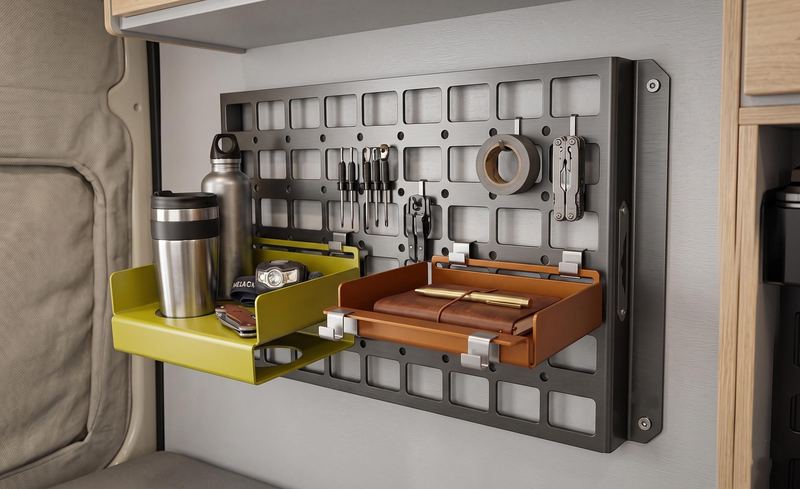 Modular MOLLE panel on a van wall with two fold-down trays and tools